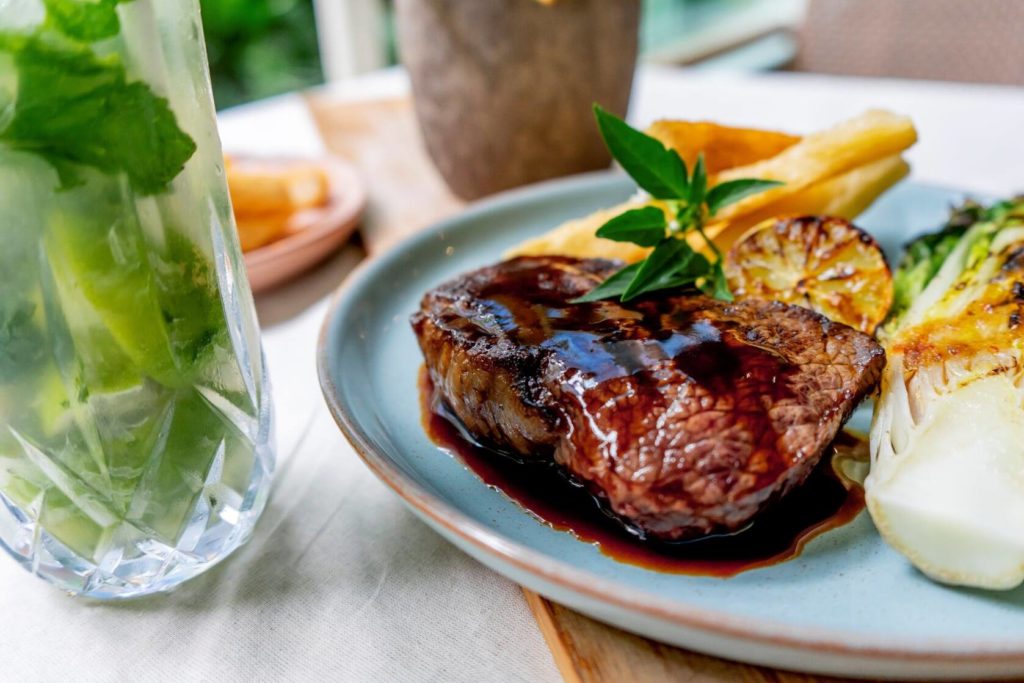 A steak and mojito on the table at Moku Bar and Grill