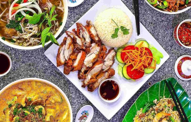 A table filled with soup, chicken, and prawn soup at Pho Street.